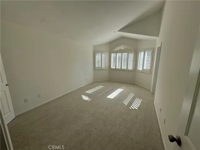 Large primary bedroom with peakaboo view of ocean