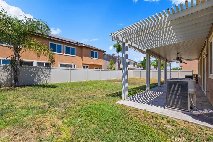 large yard with vinyl fencing and alumawood patio cover