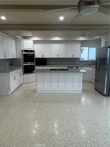 View of kitchen from the den. Lots of storage and newer cooktop.