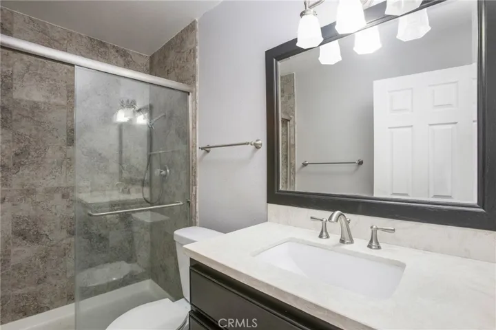 Primary bath with glass shower enclosure.