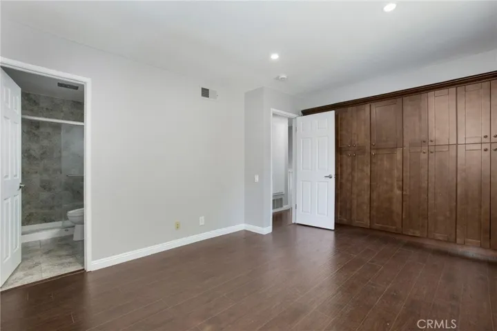 Primary suite with bath and built in​​‌​​​​‌​​‌‌​​‌​​​‌‌​​​‌​​‌‌​​‌‌​​‌‌​​​​ closet.