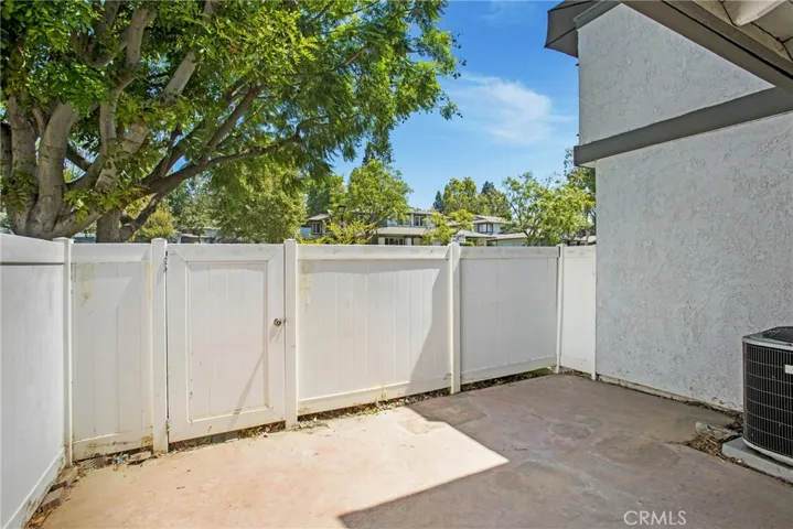 Spacious patio with vinyl fencing for privacy.