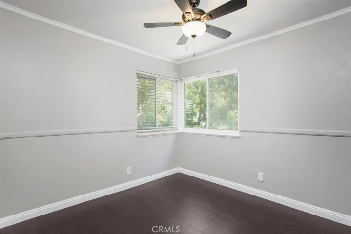 Third bedroom with new flooring, ceiling fan and built in closet.