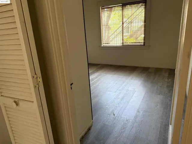 Unfurnished bedroom featuring wood finished floors