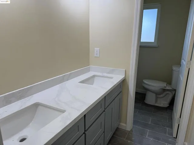 Bathroom with toilet and double vanity