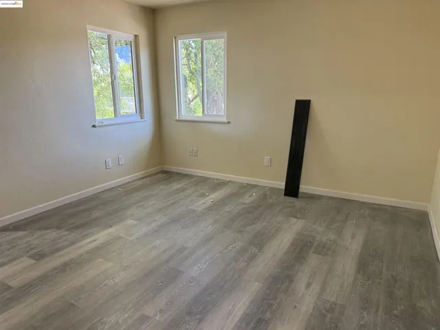 Spare room with wood finished floors and baseboards