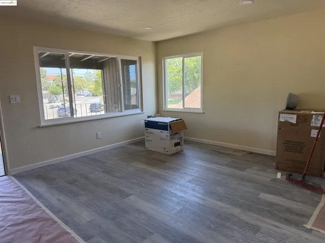 Spare room featuring wood finished floors and a textured ceiling