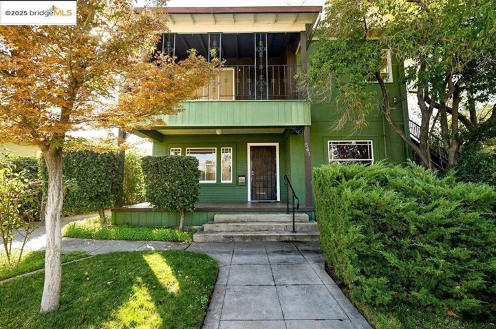 View of exterior entry featuring a balcony, a porch, and stucco siding
