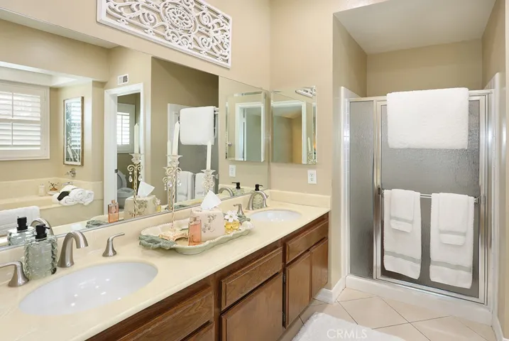 Primary bathroom with dual sinks and walk in shower