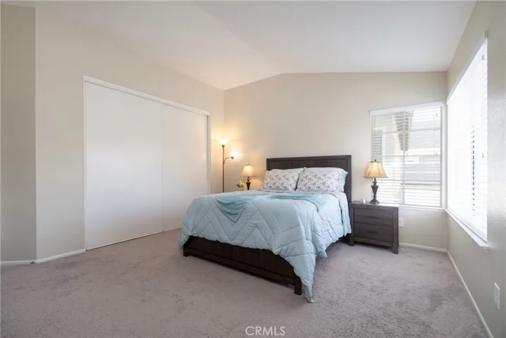 Primary suite under a vaulted ceiling and extra closet space