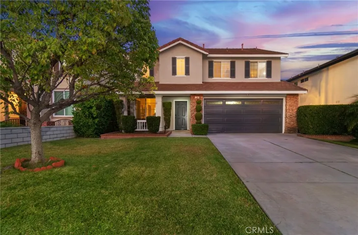 Inviting curb appeal with a covered porch entry and healthy lawn