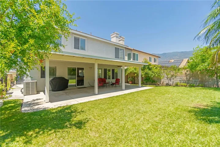 Expansive backyard with patio cover