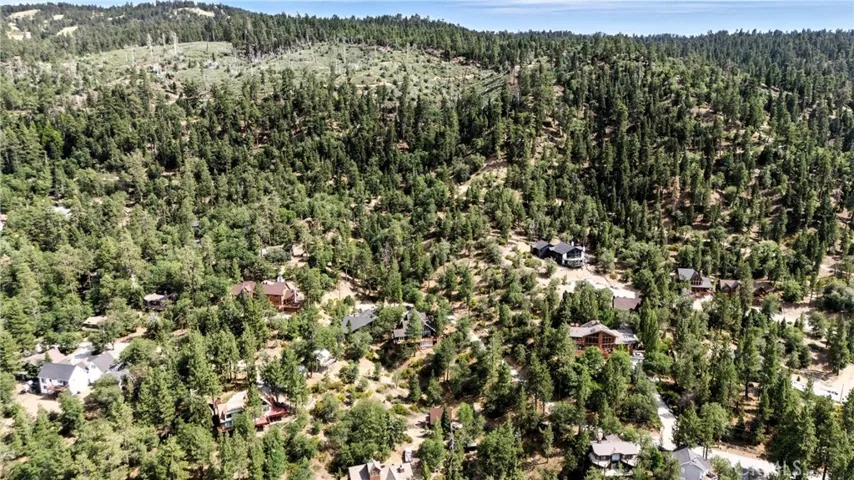 Drone aerial view overlooking lot/forest