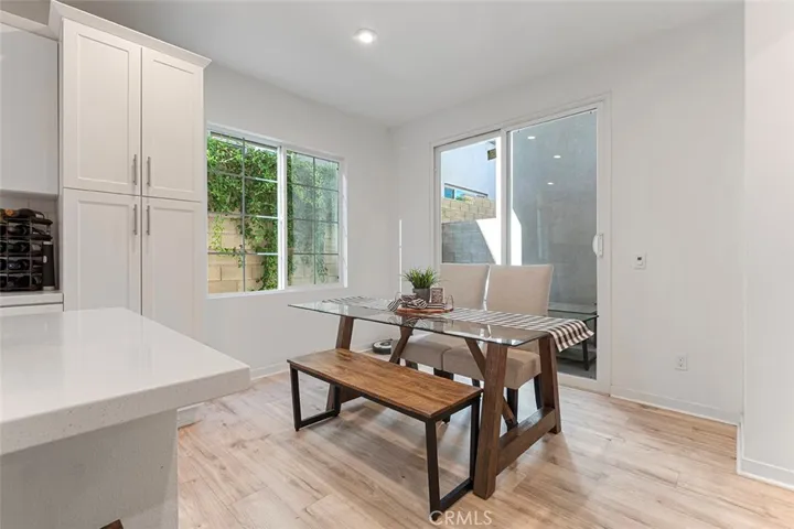 Dining area has sliders to the concrete patio. To the right is access to the powder room and door to the garage.