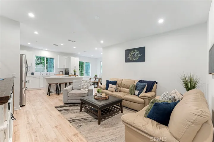 Once inside, one will note how high the ceilings are with recessed lighting and the inviting open space living welcoming you in.