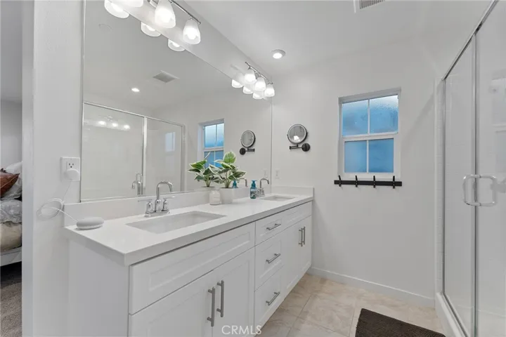 Primary en suite with dual sinks, large shower and soft close cabinets/drawers. Private commode (not shown)