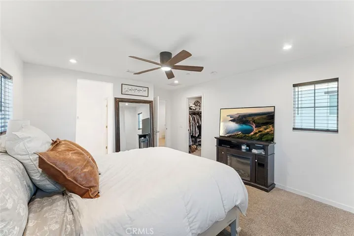 Primary bedroom has walk in closet, ceiling fan, recessed lighting and en suite.