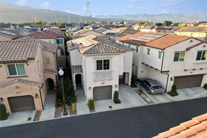 Solar is leased. $200/month. Tile roof. Stand alone no shared walls home with 2 car garage. Foothills in the distance.