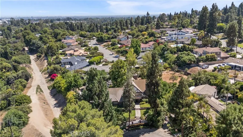 Overhead view of home and adjacent trails below