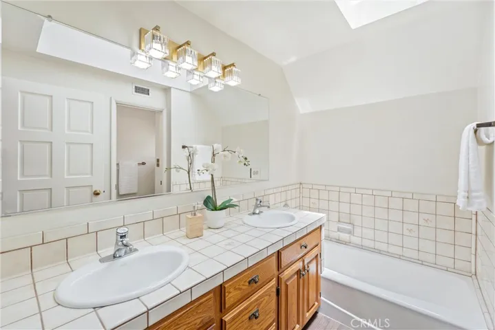 Upstairs Hallway bathroom located between Bedrooms 3 and 4 at top of stairs