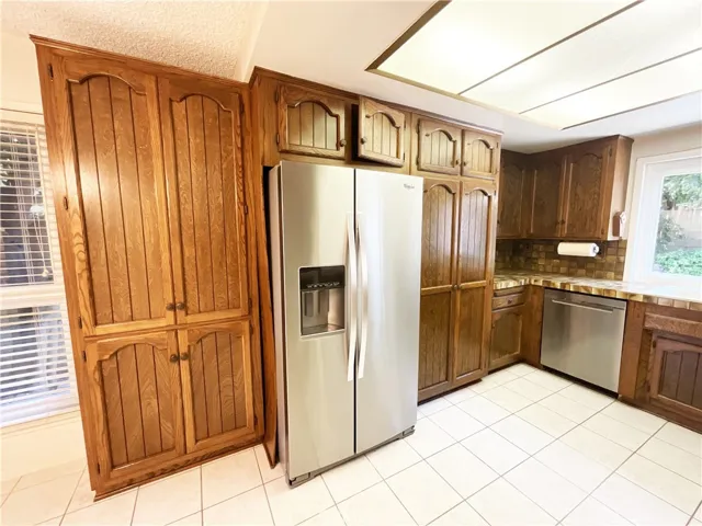 Kitchen with stainless steel appliances and large pantry space~