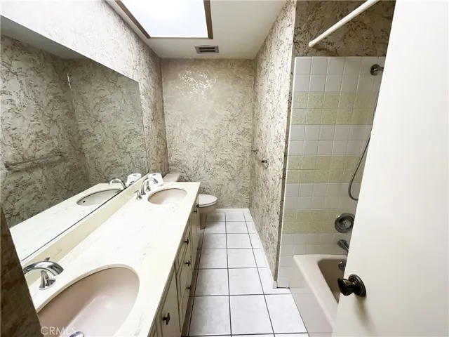 Hall bath with dual sinks, and bathtub w/shower overhead~