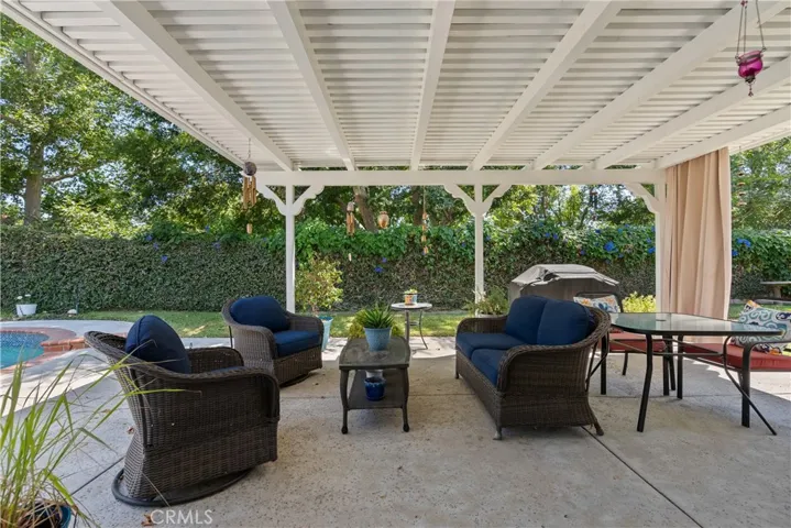 The Yard is INCREDIBLE!!! Gorgeous covered patio, sparkling pool and spa and grass area! Privacy Abounds