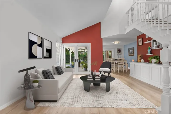 Virtually staged living room with vaulted ceilings and beautiful french doors out to your covered patio and backyard oasis