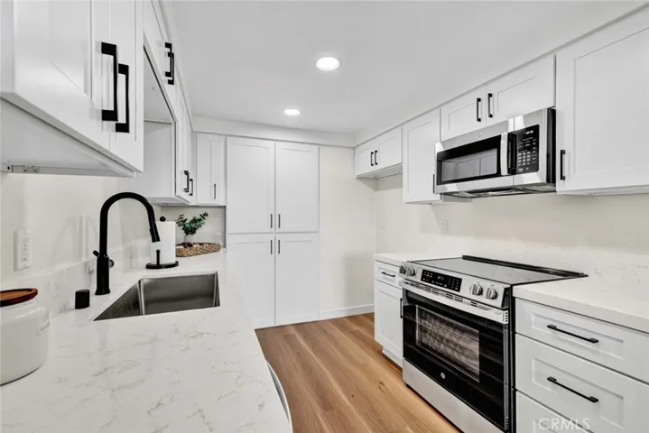 Brand new kitchen with soft close cabinets and drawers, gorgeous quartz countertops, and new stainless steel appliances.