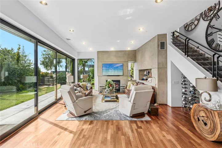Living room with gas fireplace that opens to backyard