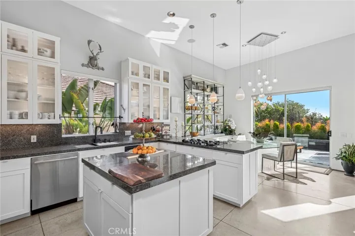 Gourmet kitchen with granite countertops, walk-in pantry, and high-end appliances.