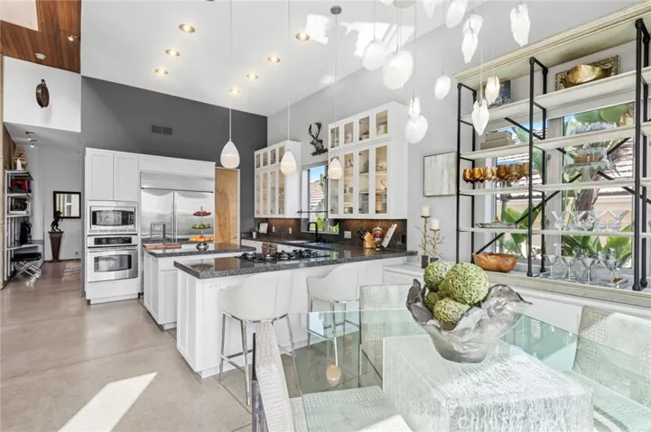 Gourmet kitchen with granite countertops, walk-in pantry, and high-end appliances.