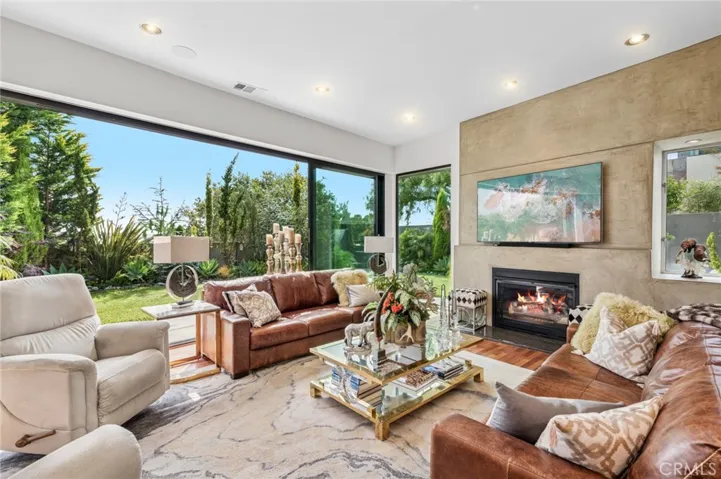 Living room with gas fireplace that opens to backyard