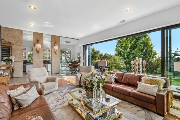 Living room with gas fireplace that opens to backyard