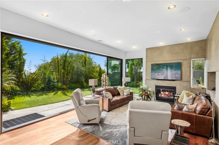 Living room with gas fireplace that opens to backyard