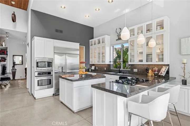 Gourmet kitchen with granite countertops, walk-in pantry, and high-end appliances.
