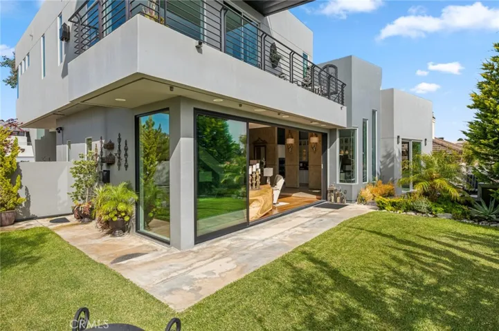 The outdoor living space is truly exceptional, featuring a built-in BBQ, fire pit, tranquil water feature, lush lawn, and multiple seating areas—perfect for entertaining or simply relaxing in your own private oasis