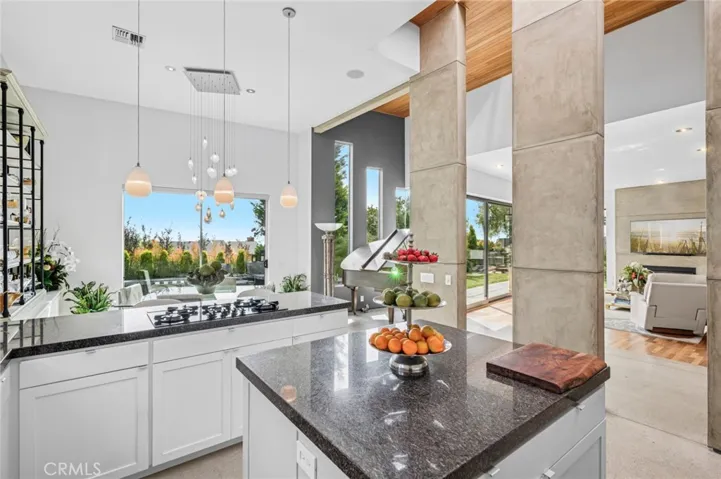 Gourmet kitchen with granite countertops, walk-in pantry, and high-end appliances.