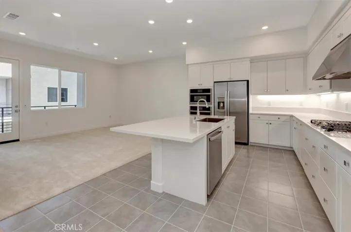Easy-clean tile floor with carpeted (easy on the feet) carpet in living room