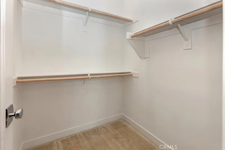 Generous walk-in closet with mirrored door (mirror both sides)