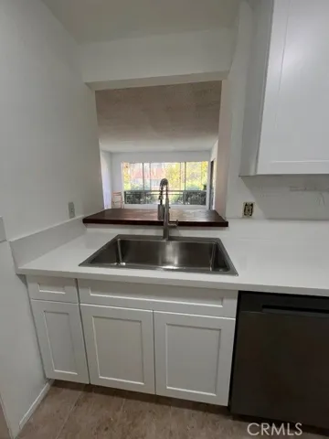 Kitchen facing the living room windows.