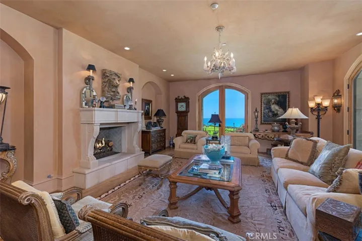 Living Room with Plaster walls looks out over ocean.  Fireplace for cozy settings.
