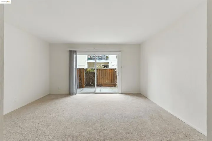 Spare room featuring light colored carpet
