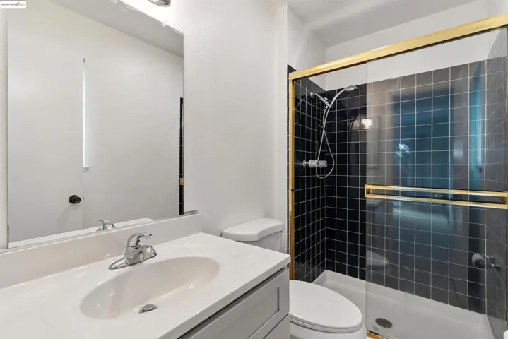 Bathroom with a stall shower and vanity