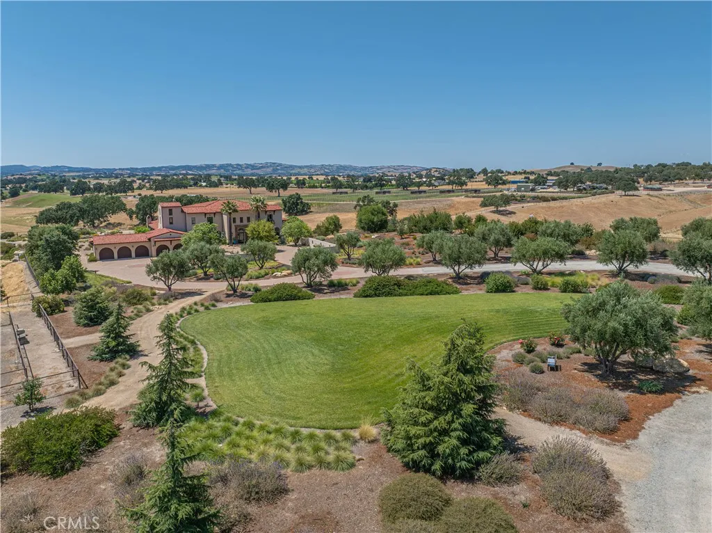 Lush landscaping thoughtfully separates the main residence from the barn/shop, enhancing privacy and visual appeal.