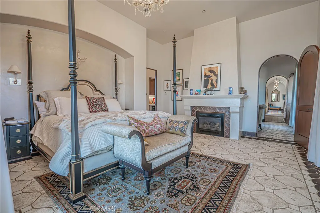 The barrel-vaulted Venetian plaster ceilings gracefully continue through the “Lady’s Lounge” and additional seating areas, leading into a primary retreat like no other.