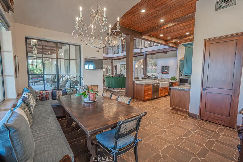 Adjacent to the kitchen is a generously sized informal dining area, complete with a powder room and direct access to the outdoor living space.