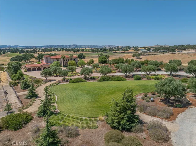 Lush landscaping thoughtfully separates the main residence from the barn/shop, enhancing privacy and visual appeal.