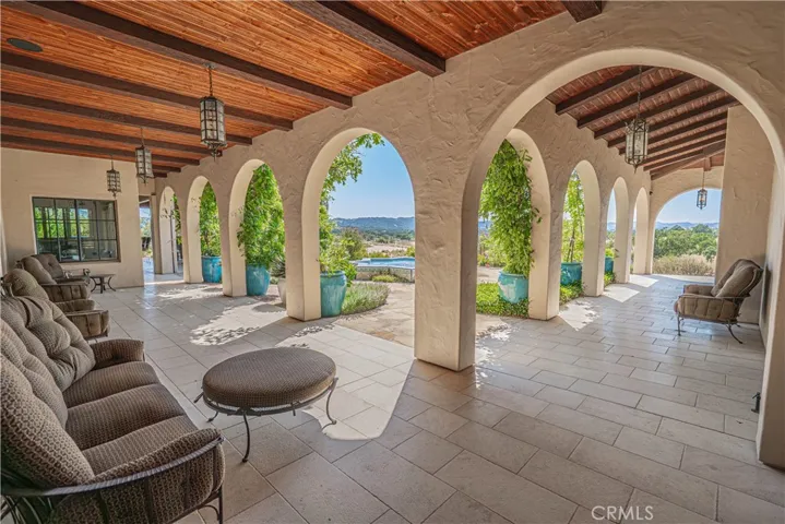 Multiple arcades extended throughout much of the home, beautifully framing the surrounding views of the property.