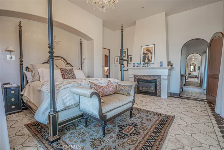 The barrel-vaulted Venetian plaster ceilings gracefully continue through the “Lady’s Lounge” and additional seating areas, leading into a primary retreat like no other.